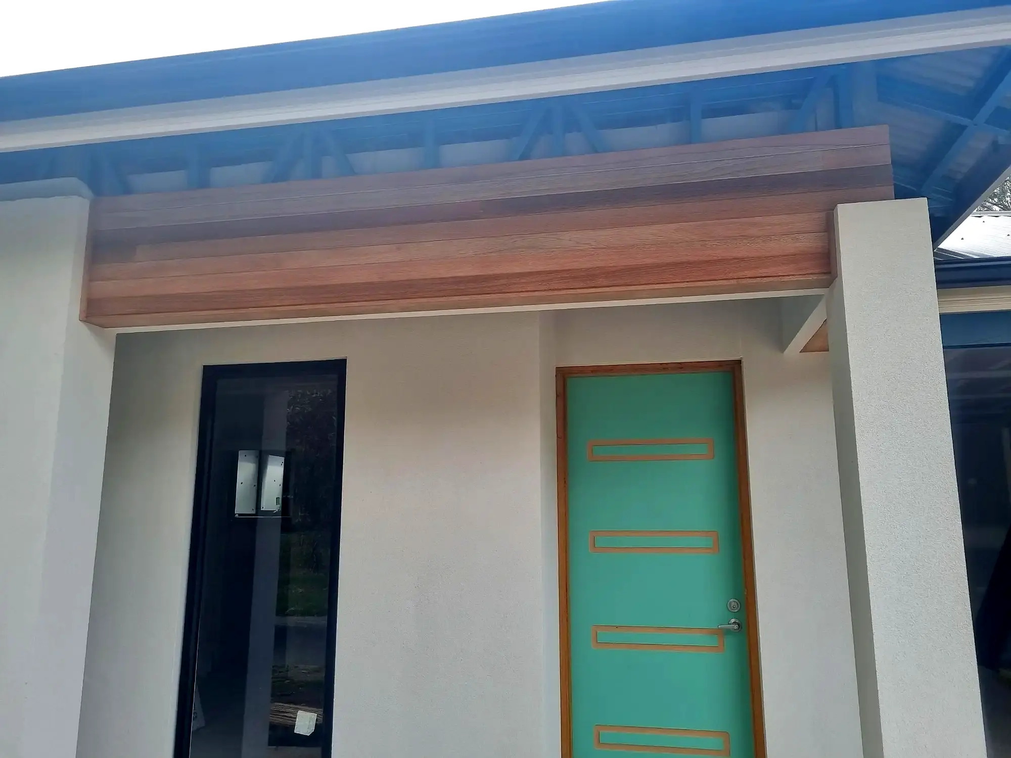The finished entry: a timber portal over a bold feature door