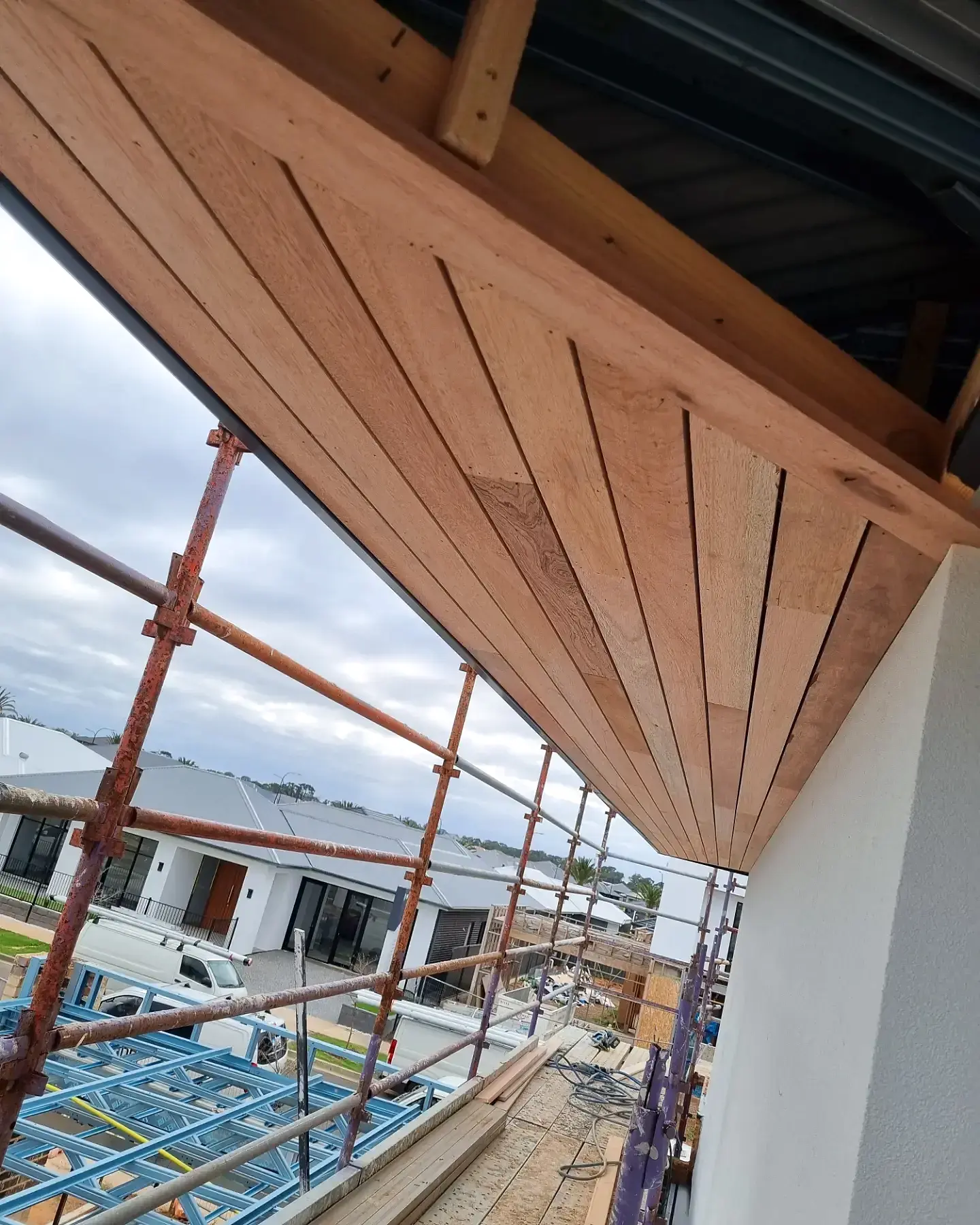 Warm timber cladding being fitted to the portal