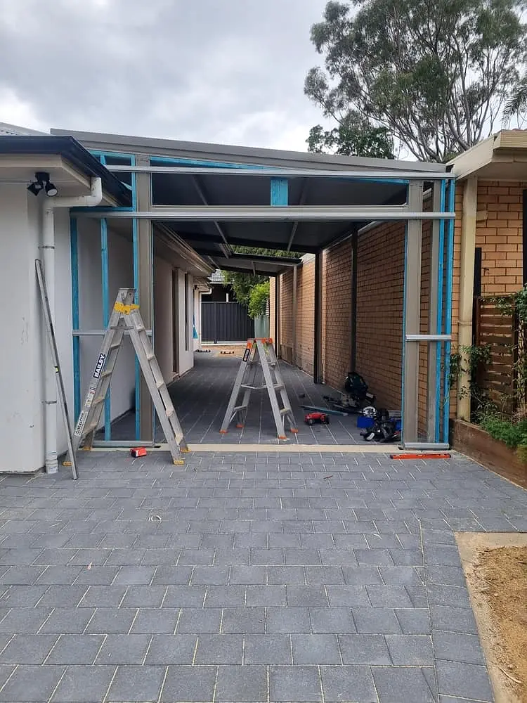 An existing carport being converted into an enclosed garage, framing in progress